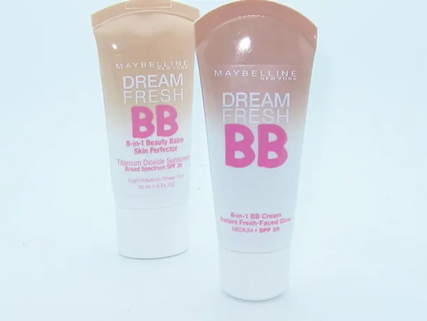 Main appliquant une BB crème par petites touches sur une joue avec le bout des doigts